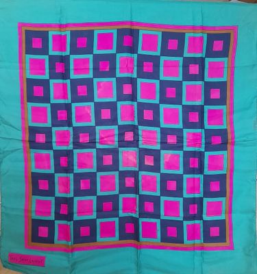 a blue and pink quilt with squares on it