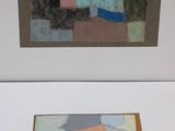 two paintings of different colors and shapes are on display in a white frame