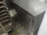 stainless steel counter top in a commercial kitchen with stairs leading up to it