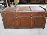 a brown trunk sitting on the floor in a room