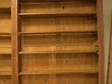 a large wooden bookcase with many shelves in it