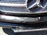 a close up of a car with a mercedes emblem on the front of it