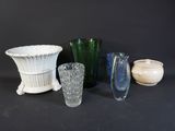 many different vases and bowls sitting on a table