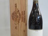 a bottle of wine sitting next to a wooden box