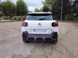 the rear end of a white citrole parked in a parking lot