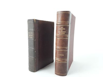 two old books sitting next to each other on a white surface