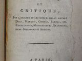 an old book that is open on a table