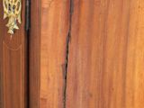 a close up of a wooden cabinet with a marble top