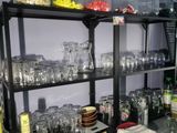 many glasses on the shelves in the room