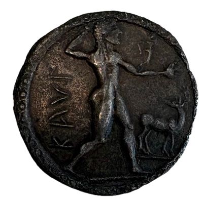 une vieille pièce sur laquelle figurent une femme et un chien