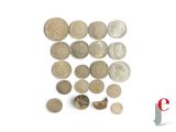 a lot of coins that are on a white surface