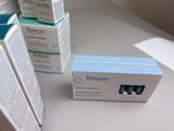 three boxes on a table with a toothbrush and toothpaste in them