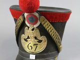 a black hat with a red pom pom on it