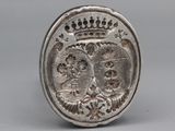 an old silver coin with a crown on it sitting on top of a table