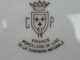 the plate has a crown on top of it and a crown on the bottom of it