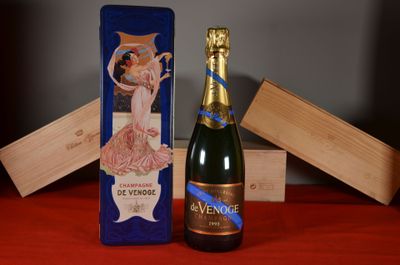 a bottle of champagne sitting next to a wooden box