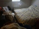 a bed in a small room with a skylight above it