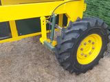 a tractor that is parked in front of a fence