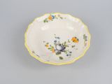 an image of a small bowl with flowers on it on a gray surface