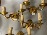 a wall mounted candle holder and a wall sconce on the wall
