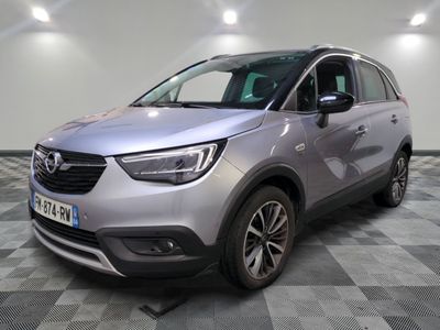a silver car parked in a room with a checkered floor