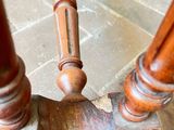 a close up of a wooden table on a brick floor