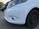a white car that is parked in a parking lot