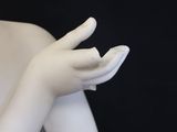 a white statue of a woman holding her hands out