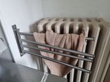 a towel rack with towels hanging on it in a bathroom