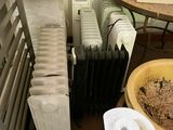 several rolls of toilet paper are sitting on a table next to a radiator