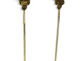 two gold and green hair pins with a crown on top