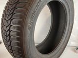 a close up of a tire on a white surface next to a pair of scissors