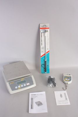 a small electronic scale sitting on a table next to other items
