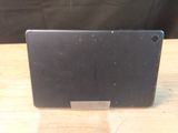 a black tablet computer sitting on a wooden table