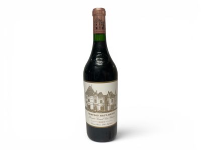 a bottle of wine sitting on top of a white table