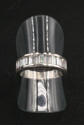 a close up of a silver ring with baguets on it