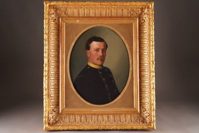 an old picture of a man in a military uniform in a gold frame