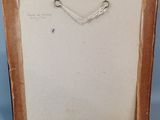 an old picture frame with a drawing of a man ' s face on it