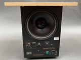 a close up of a speaker on a wooden shelf