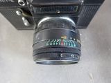 a camera with a lens attached to it on a table