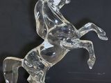 a glass horse that is standing on its hind legs