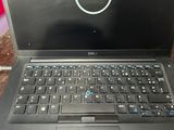 dell laptop computer sitting on top of a wooden table