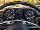 a steering wheel and dashboard of a car with gauges on