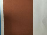 a piece of brown paper with a white square on it