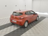 the orange car is parked in the garage on the checkered floor