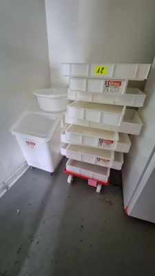 a stack of bins in the corner of a room
