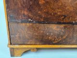 a wooden dresser with a drawer on top of it