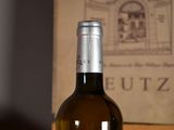 a bottle of wine sitting on a table next to a box
