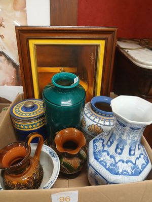 many vases and bowls in a box on the floor