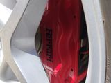 a close up of a tire with a red brake disc